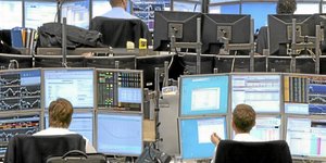Traders work in the Commerzbank AG trading room in Frankfurt, Germany, on Monday, Feb. 8, 2010. European stocks erased their decline as chemical producers and utilities advanced. Photographer: Hannelore Foerster/Bloomberg